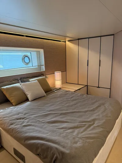  Yacht Photos Pics Luxurious bedroom in 2025 Azimut Seadeck 6 yacht with modern design and cozy bedding.