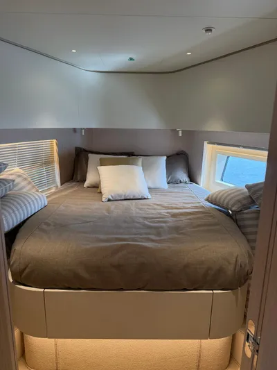  Yacht Photos Pics Luxurious bedroom interior of 2025 Azimut Seadeck 6 yacht with cozy bedding and modern design.