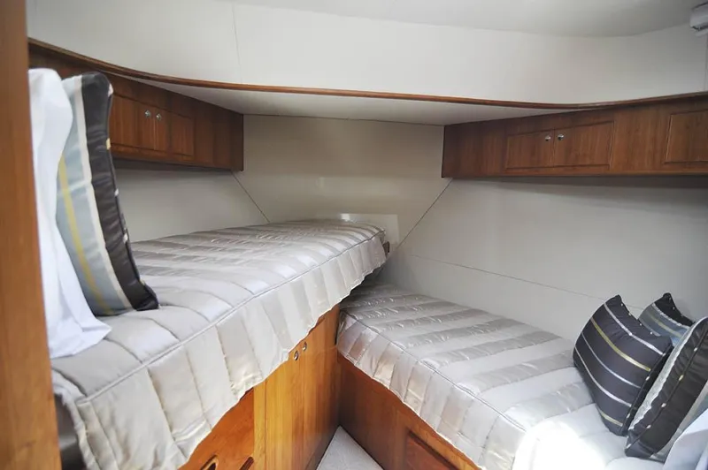  Yacht Photos Pics 2026 Alaska 47 Flybridge cabin with twin beds and wooden storage cabinets.