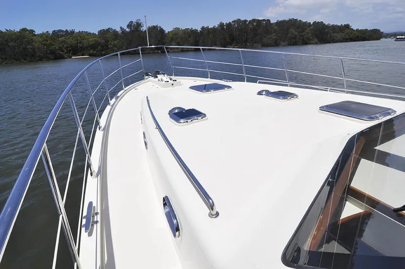  Yacht Photos Pics 2026 Alaska 47 Flybridge yacht deck with sleek design on calm water.