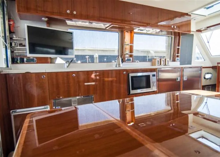  Yacht Photos Pics Luxurious interior of 2026 Alaska 47 Flybridge yacht with modern kitchen amenities.