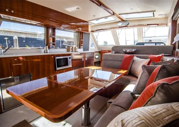  Yacht Photos Pics Luxurious interior of 2026 Alaska 47 Flybridge yacht with modern kitchen and plush seating.