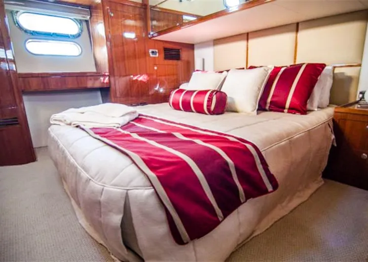  Yacht Photos Pics Luxurious bedroom interior of 2026 Alaska 47 Flybridge yacht with elegant red accents.