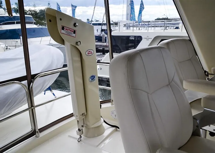  Yacht Photos Pics 2026 Alaska 47 Flybridge interior with white seating and marina view.