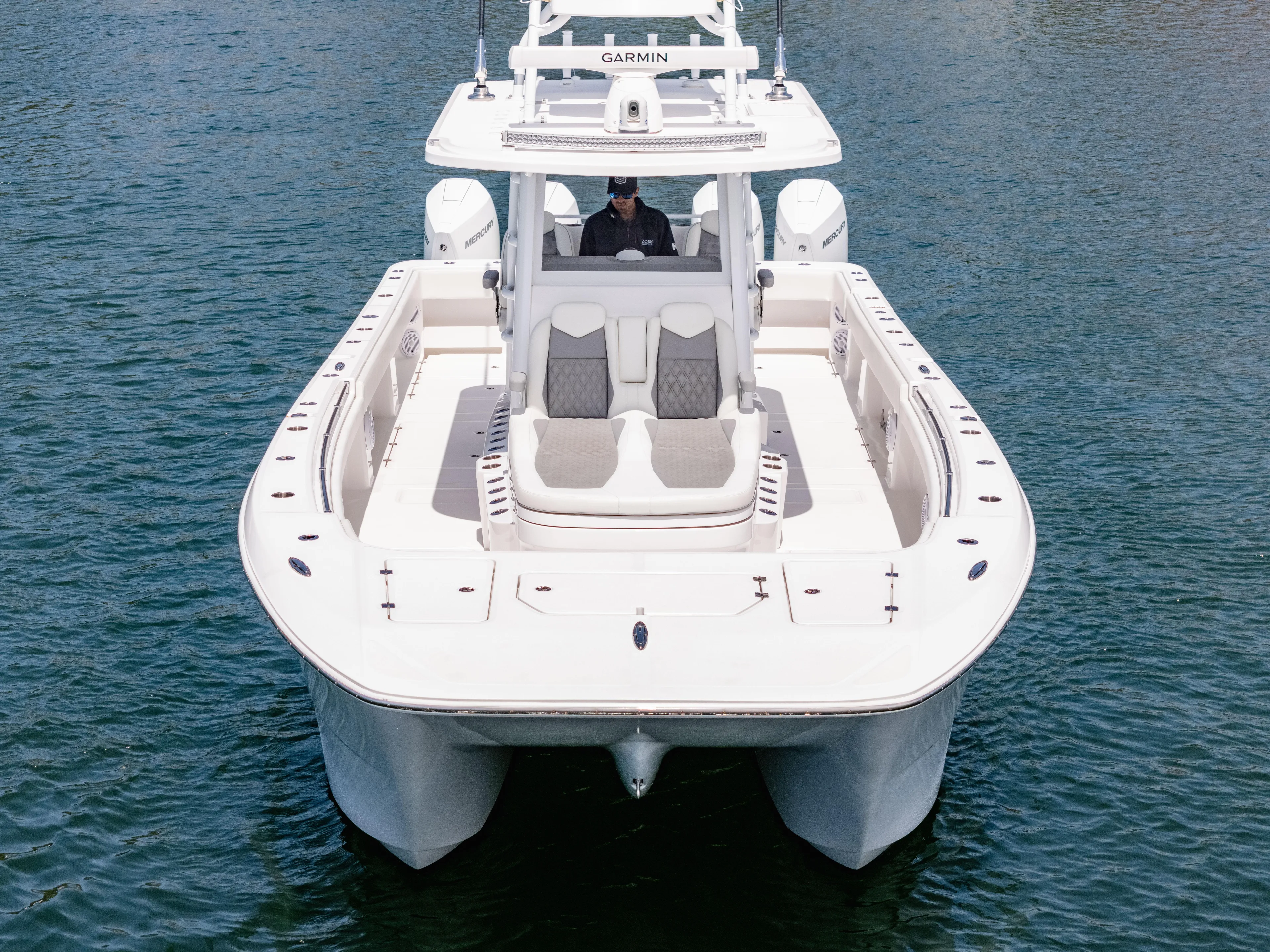  Yacht Photos Pics 2024 Invincible 35 Catamaran on water, showcasing sleek design and spacious deck.