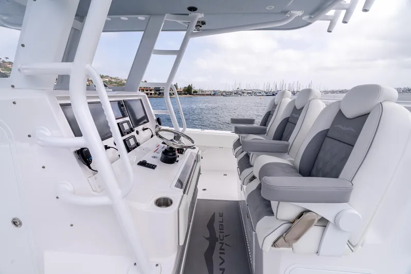  Yacht Photos Pics 2024 Invincible 35 Catamaran interior with modern helm and comfortable seating.