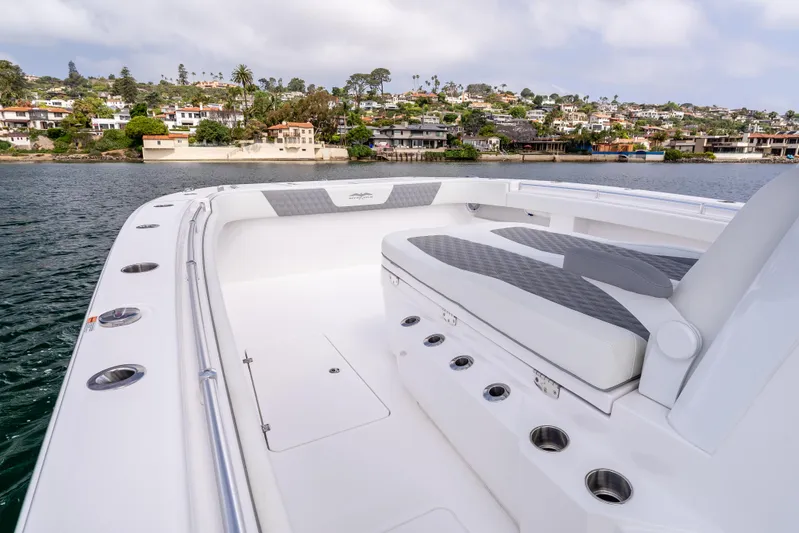  Yacht Photos Pics 2024 Invincible 35 Catamaran with spacious seating, docked near scenic waterfront homes.