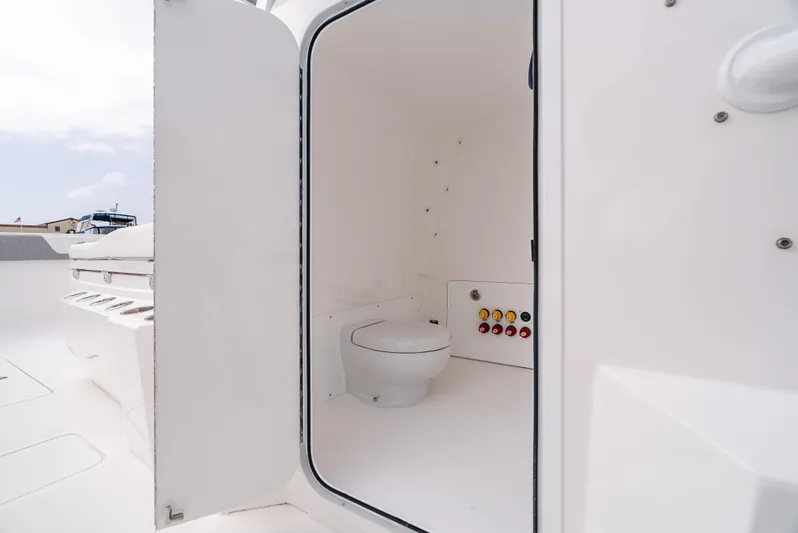  Yacht Photos Pics 2024 Invincible 35 Catamaran interior with marine toilet and control panel.