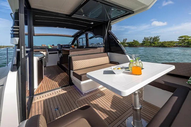  Yacht Photos Pics 2023 Galeon 425 HTS yacht interior with dining area, table, and scenic water view.
