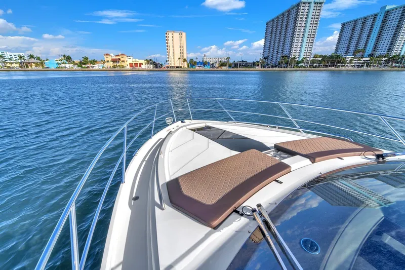  Yacht Photos Pics 2023 Galeon 425 HTS yacht cruising near coastal city skyline.