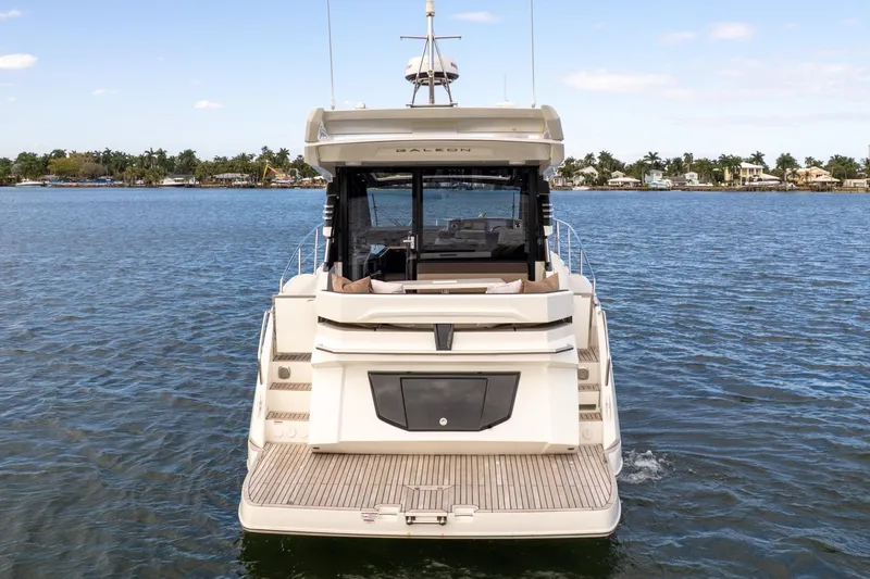  Yacht Photos Pics 2023 Galeon 425 HTS yacht on calm water, rear view showcasing deck and seating area.