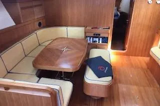 Sinfonie Sylt Yacht Photos Pics Luxurious interior of 2001 Grand Soleil 70 yacht with wooden dining area.