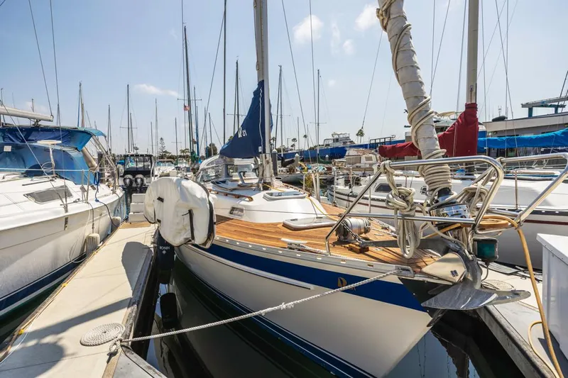 Roniin Yacht Photos Pics 2003 Hallberg-Rassy HR31 sailboat docked in a marina, surrounded by other boats.