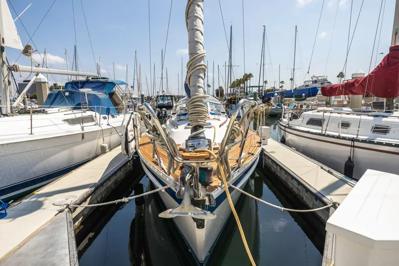 Roniin Yacht Photos Pics 2003 Hallberg-Rassy HR31 sailboat docked in marina, surrounded by other boats.