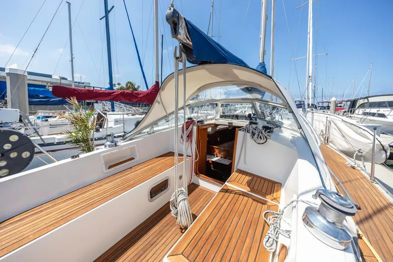 Roniin Yacht Photos Pics 2003 Hallberg-Rassy HR31 sailboat with teak deck, docked in a sunny marina.