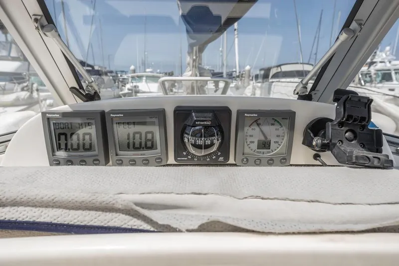 Roniin Yacht Photos Pics Hallberg-Rassy HR31 2003 yacht cockpit with navigation instruments and marina view.