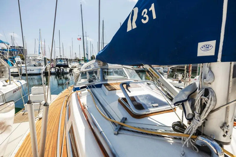 Roniin Yacht Photos Pics 2003 Hallberg-Rassy HR31 sailboat docked in a marina, showcasing deck and rigging.