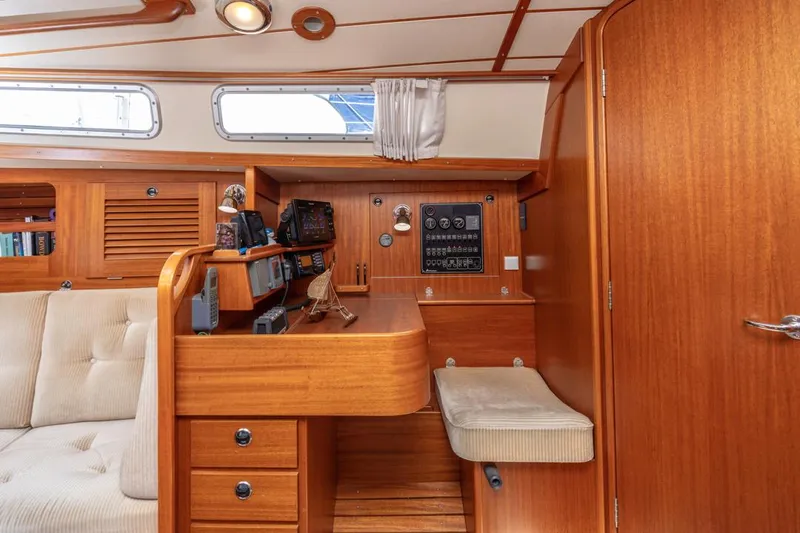Roniin Yacht Photos Pics Hallberg-Rassy HR31 2003 yacht interior with navigation station and wooden cabinetry.