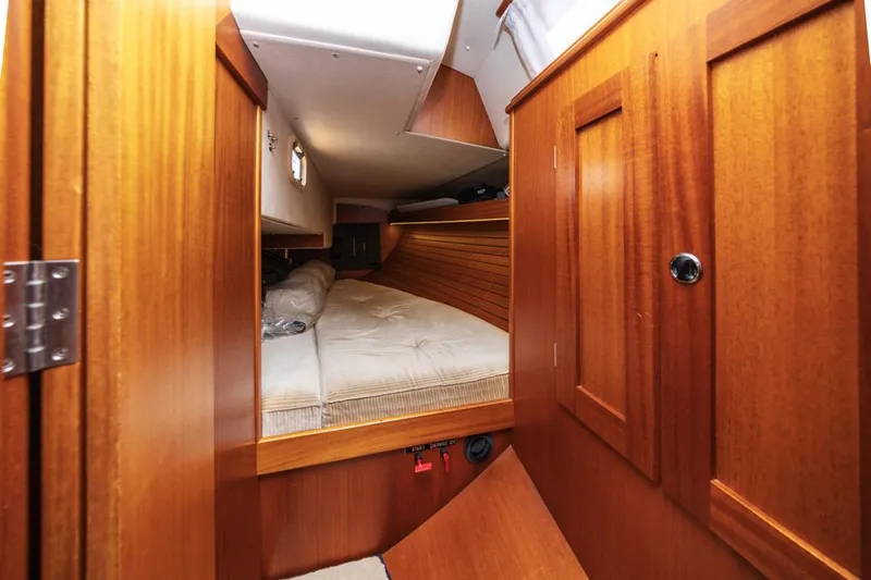 Roniin Yacht Photos Pics Cozy cabin interior of 2003 Hallberg-Rassy HR31 sailboat with wooden finish.