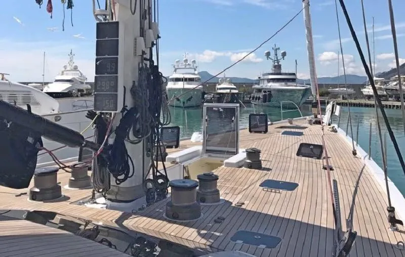  Yacht Photos Pics Deck view of 2006 CNB 117 yacht in marina, surrounded by luxury boats.