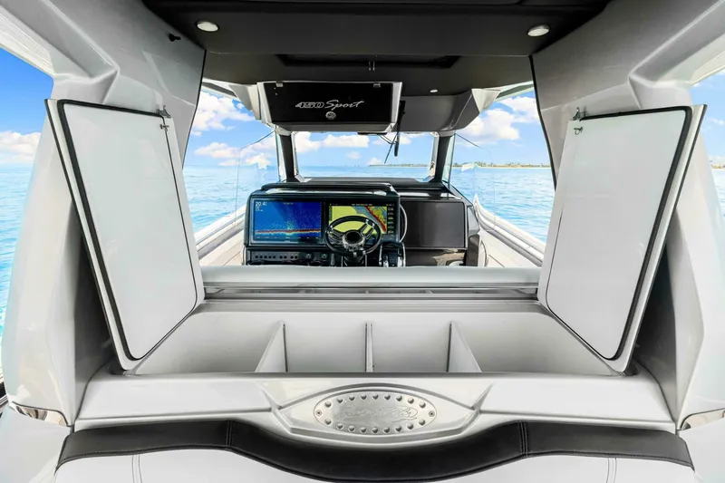 Rod's Jewel Yacht Photos Pics 2017 Nor-Tech 450SS boat interior with open storage, steering wheel, and navigation screens.