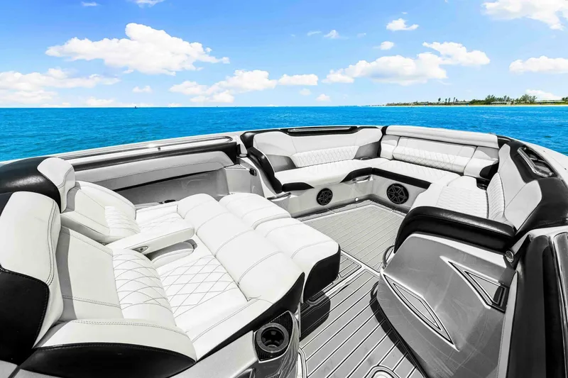 Rod's Jewel Yacht Photos Pics Luxurious 2017 Nor-Tech 450SS boat interior with white seating, set against a vibrant ocean backdrop.