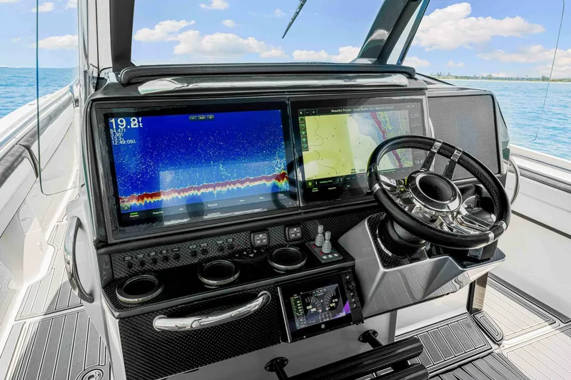 Rod's Jewel Yacht Photos Pics 2017 Nor-Tech 450SS boat dashboard with advanced navigation screens and steering wheel.