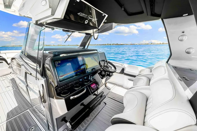 Rod's Jewel Yacht Photos Pics 2017 Nor-Tech 450SS boat interior with modern dashboard and luxurious seating, overlooking blue ocean.