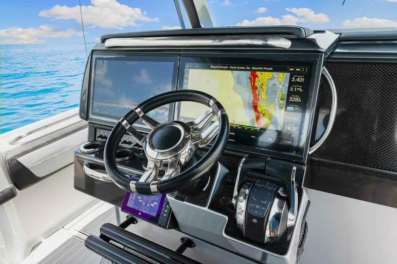 Rod's Jewel Yacht Photos Pics 2017 Nor-Tech 450SS boat dashboard with navigation screens and steering wheel.