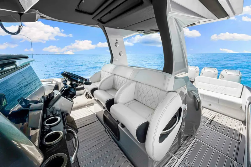 Rod's Jewel Yacht Photos Pics Luxurious 2017 Nor-Tech 450SS boat interior with white seating and ocean view.