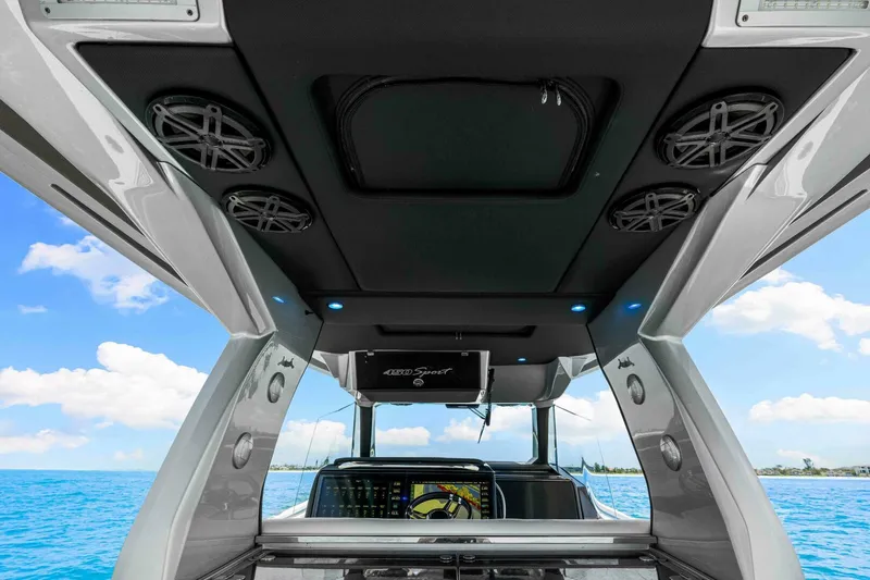 Rod's Jewel Yacht Photos Pics Interior view of 2017 Nor-Tech 450SS boat with speakers and ocean backdrop.