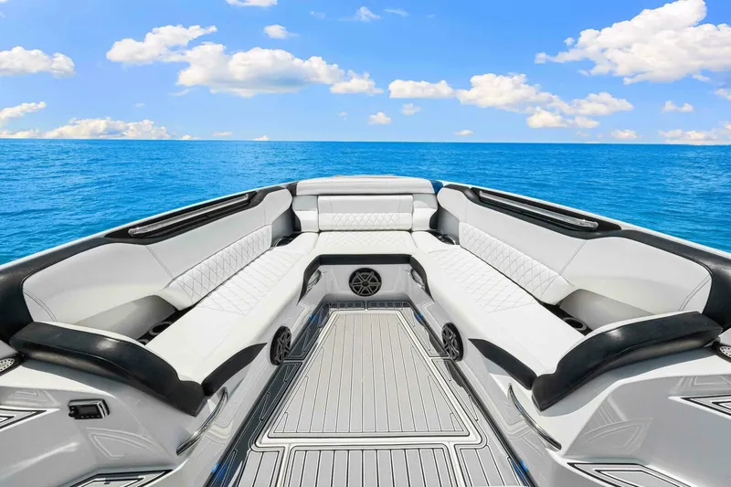 Rod's Jewel Yacht Photos Pics 2017 Nor-Tech 450SS boat interior with luxurious seating, set against a clear blue ocean backdrop.