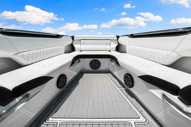 Rod's Jewel Yacht Photos Pics Luxurious interior of 2017 Nor-Tech 450SS boat with white quilted seating under blue sky.