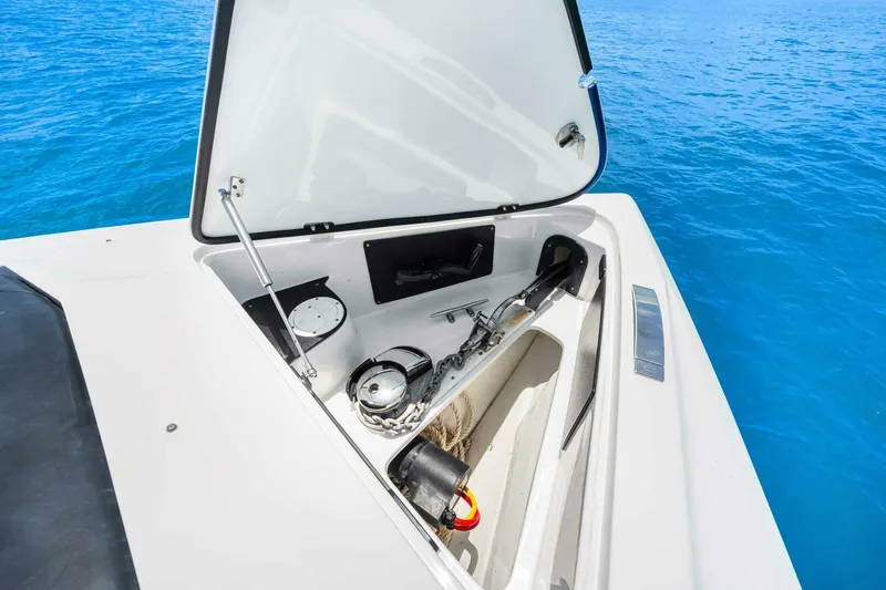 Rod's Jewel Yacht Photos Pics Open storage compartment on 2017 Nor-Tech 450SS boat, with anchor and equipment, against blue ocean backdrop.