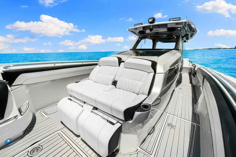 Rod's Jewel Yacht Photos Pics 2017 Nor-Tech 450SS boat interior with luxurious seating, set against a clear blue ocean backdrop.