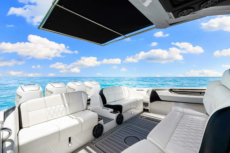 Rod's Jewel Yacht Photos Pics Luxurious 2017 Nor-Tech 450SS boat interior with white seating, ocean view, and blue sky.