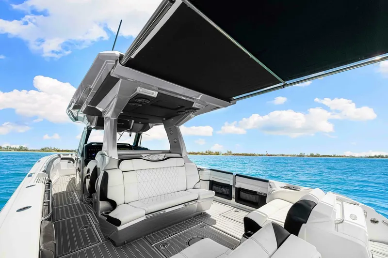 Rod's Jewel Yacht Photos Pics 2017 Nor-Tech 450SS luxury boat interior with seating, canopy, and ocean view.