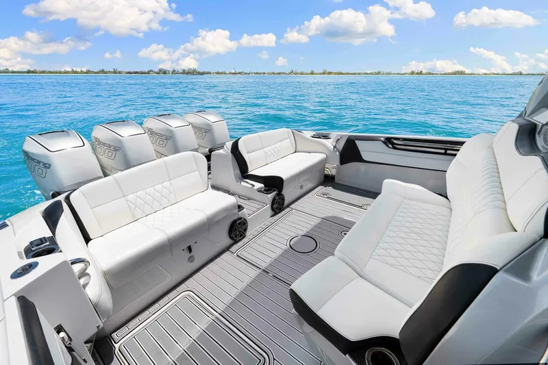 Rod's Jewel Yacht Photos Pics Luxurious 2017 Nor-Tech 450SS boat interior with plush seating and multiple engines on a sunny day.