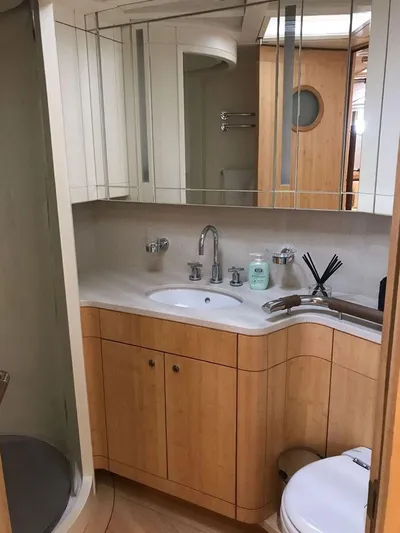  Yacht Photos Pics Luxurious yacht bathroom with wooden cabinetry, modern fixtures, and mirrored accents, CNB 117, 2006 model.