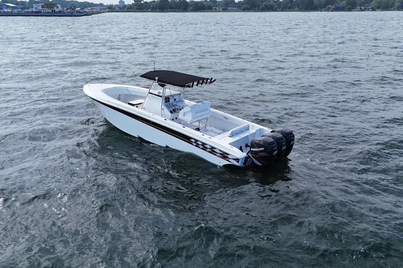  Yacht Photos Pics 2005 Fountain 34 Sportfish CC Open Bow boat on open water, featuring twin Mercury engines.