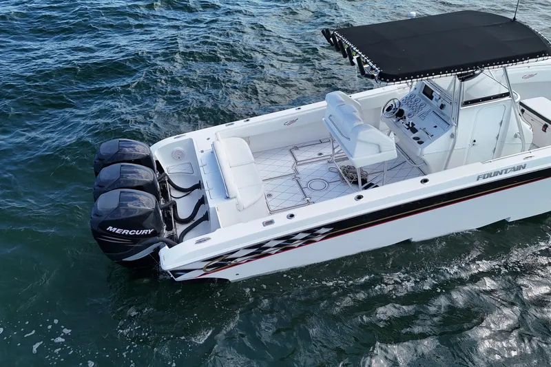  Yacht Photos Pics 2005 Fountain 34 Sportfish CC Open Bow boat with triple Mercury engines on water.