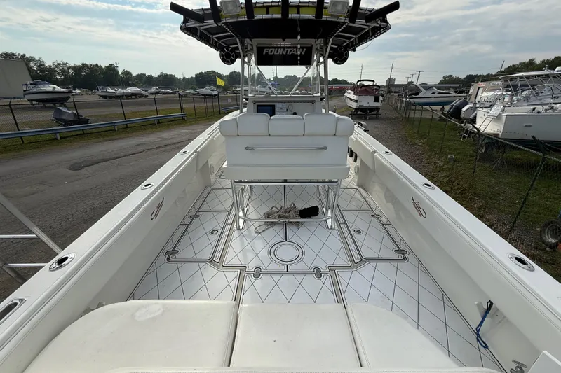  Yacht Photos Pics 2005 Fountain 34 Sportfish CC Open Bow boat, spacious deck, marina background.