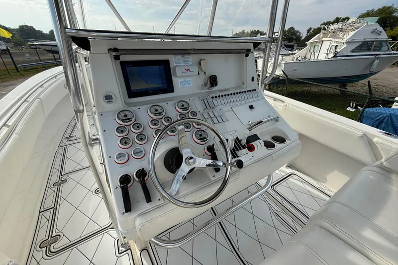  Yacht Photos Pics 2005 Fountain 34 Sportfish CC Open Bow boat dashboard with steering wheel and controls.
