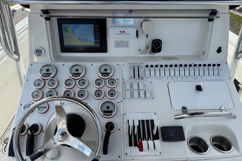  Yacht Photos Pics Control panel of a 2005 Fountain 34 Sportfish CC Open Bow boat with gauges and navigation screen.