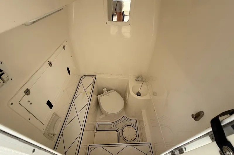  Yacht Photos Pics 2005 Fountain 34 Sportfish CC Open Bow boat interior with toilet and storage compartments.