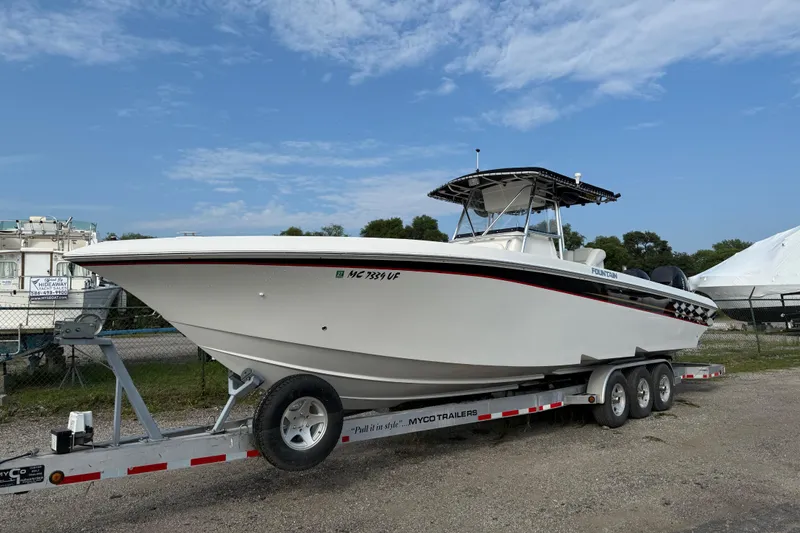  Yacht Photos Pics 2005 Fountain 34 Sportfish CC Open Bow on trailer, parked outdoors under blue sky.