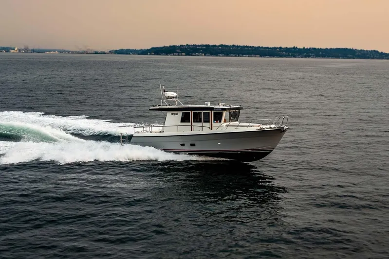  Yacht Photos Pics 2019 Targa 35 boat cruising on open water at sunset.