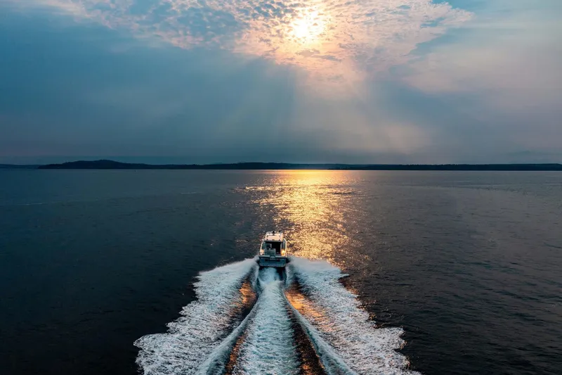  Yacht Photos Pics 2019 Targa 35 boat cruising at sunset on open water.