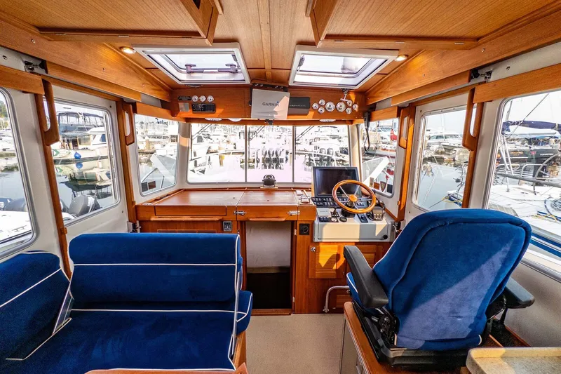  Yacht Photos Pics Interior of 2019 Targa 35 boat with blue seating and wooden dashboard.