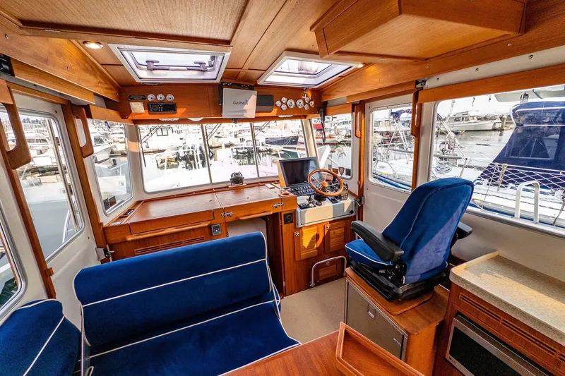  Yacht Photos Pics Interior of 2019 Targa 35 boat with wooden finish and blue seating.